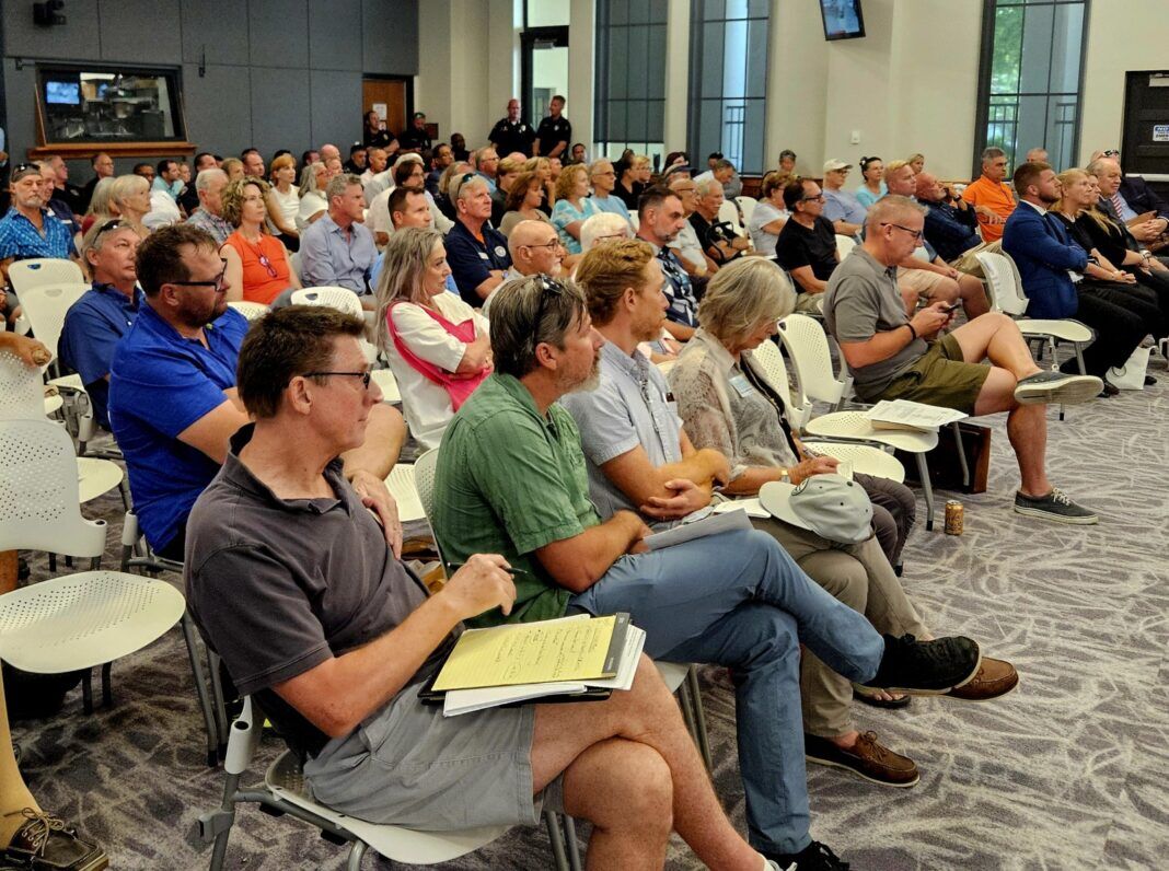 packed city hall a large group of people sitting in a room