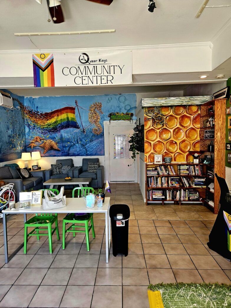 a room filled with furniture and a mural on the wall