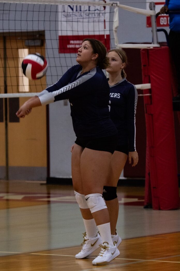 a couple of women playing a game of volleyball