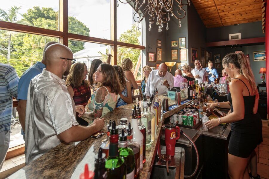 a group of people standing around a bar