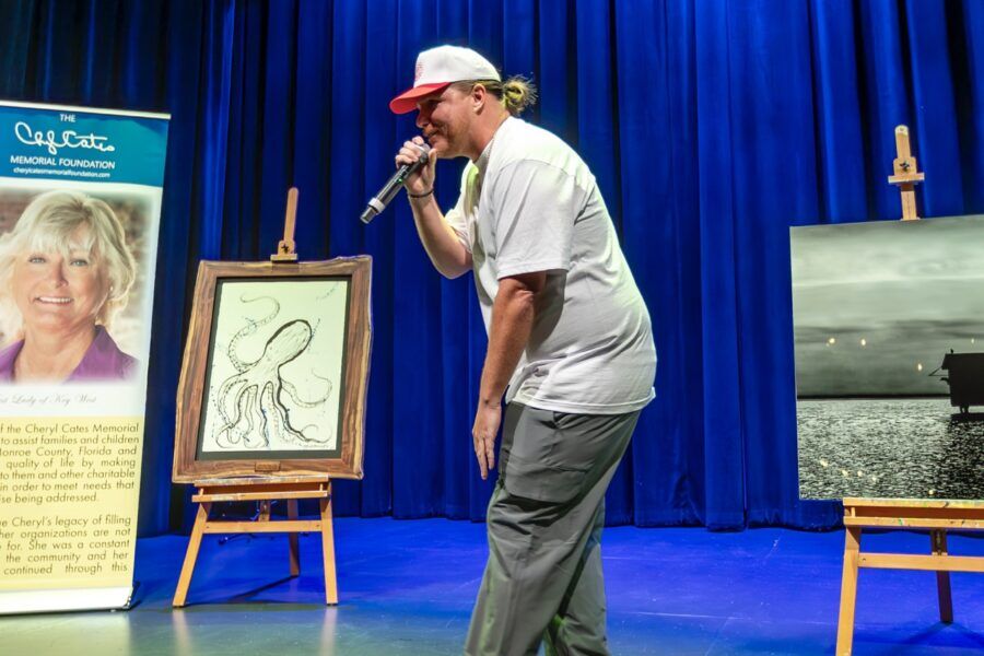 a man standing on a stage holding a microphone