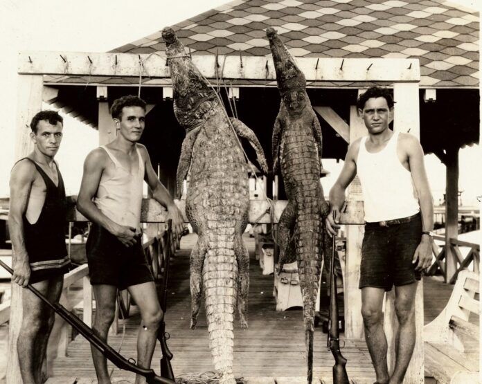 23985834461_b45baa03a2_k (1) a group of men standing next to each other on a dock