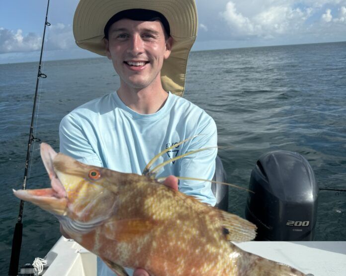 001 a man on a boat holding a large fish