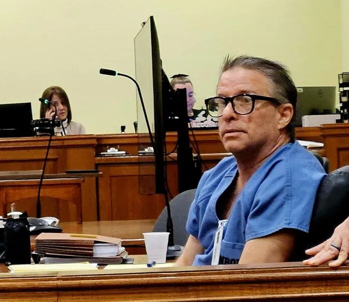 Preston Brewer in court a man sitting at a table in a courtroom