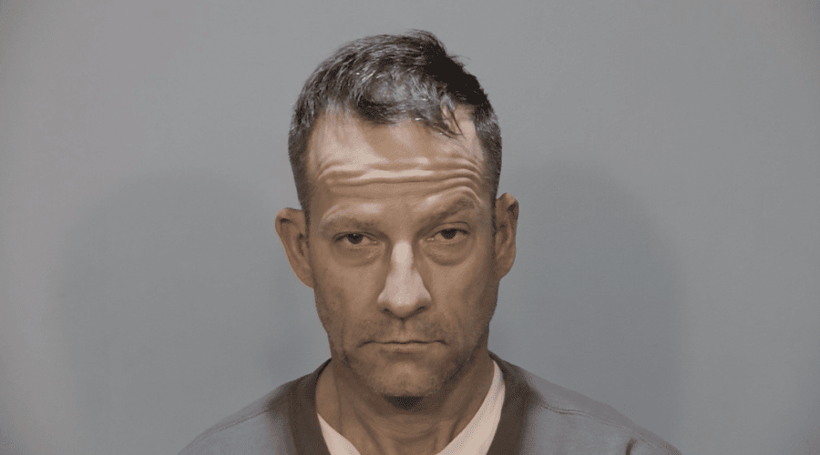 a man in a gray jacket and a white shirt