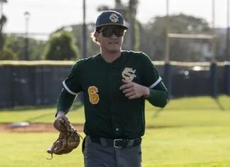 a man in a baseball uniform holding a catchers mitt