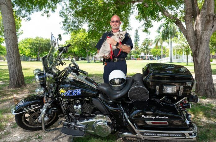 Chief with Kai a man holding a dog standing next to a motorcycle