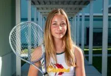 HURRICANE GIRLS, DOLPHIN BOYS TRADE WINS ON THE TENNIS COURT a young woman holding a tennis racquet on a tennis court