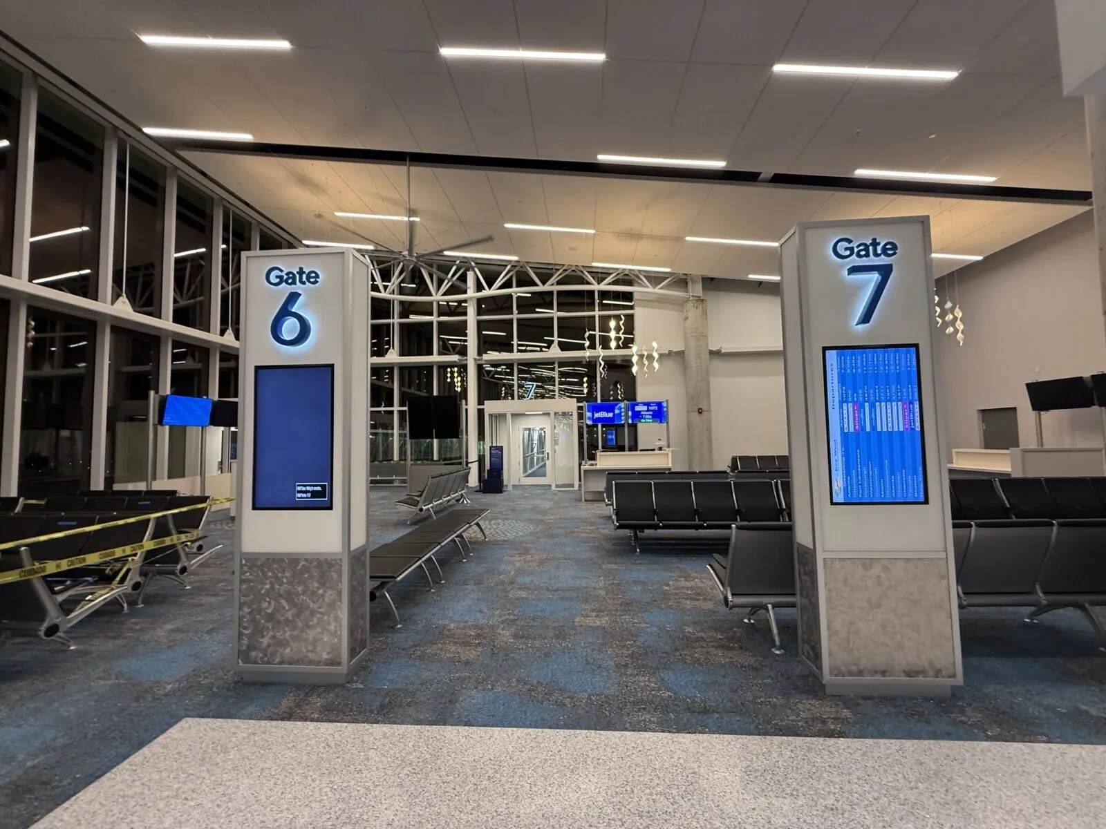 an airport terminal with a row of empty seats