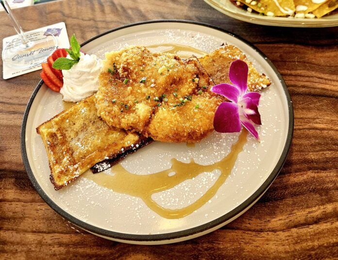 chicken and waffles a plate of food on a wooden table