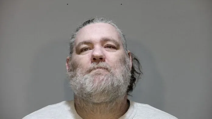 a man with a beard and a white shirt