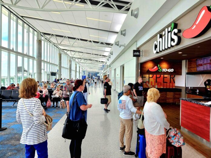 a group of people waiting in line at an airport