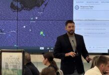 FLORIDA KEYS OFFICIALS SIMULATE POST-STORM RECOVERY WITH EMERGENCY OPERATIONS CENTER DRILL a man standing in front of a group of people