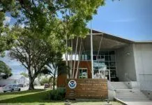 KEY WEST WEATHER EXPERTS OFFER REASSURANCE IN LIGHT OF FEDERAL CUTS the front of a building with a flag on it