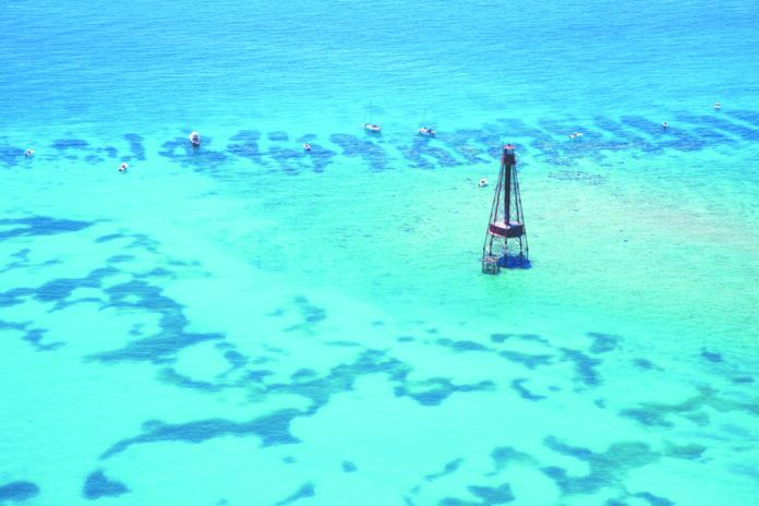 an aerial view of a sailboat in the water