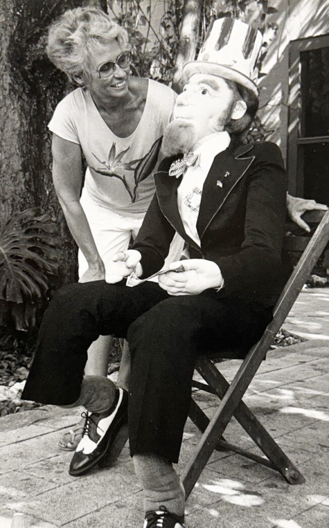 a man sitting on a bench next to a woman
