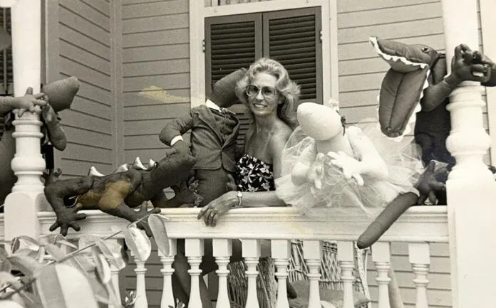 Judi and lizards Large a woman sitting on a porch with stuffed animals