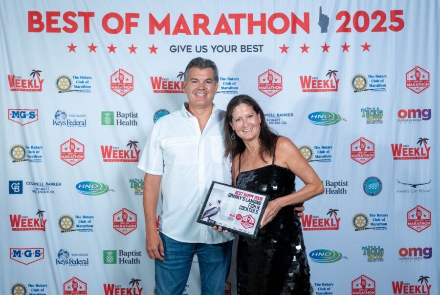 a man and a woman standing in front of a red carpet