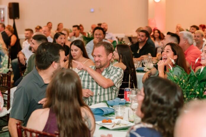a large group of people sitting at tables in a room