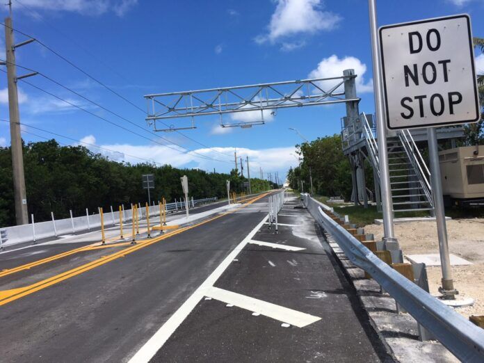 Card Sound Toll a road with a do not stop sign on it