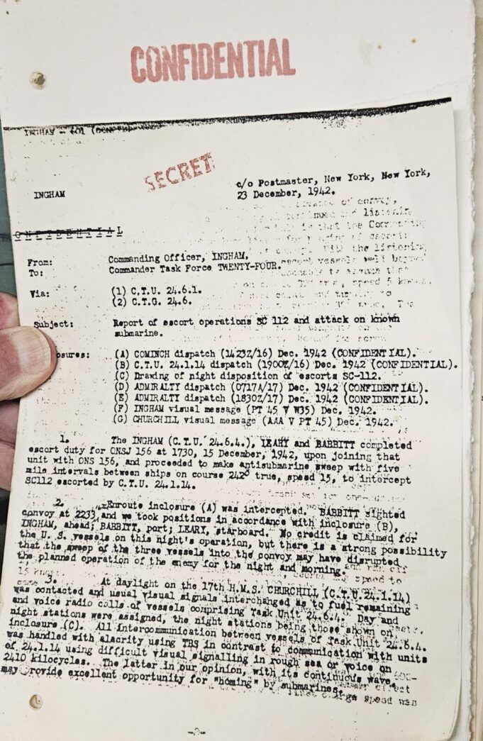 a hand holding a piece of paper with writing on it