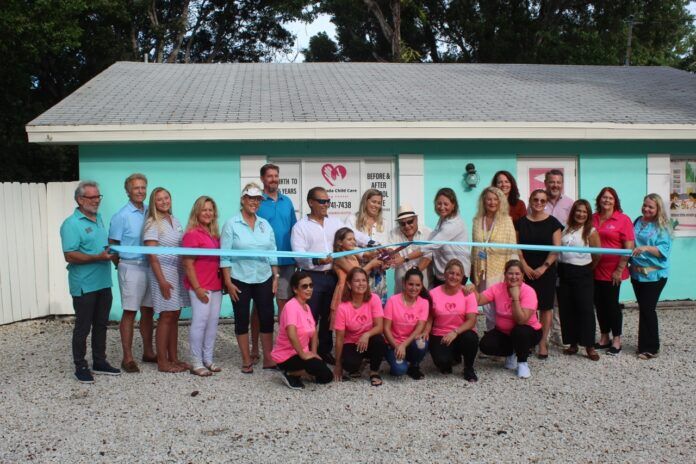 Islamorada Child Care 1 Large a group of people in pink shirts holding a ribbon