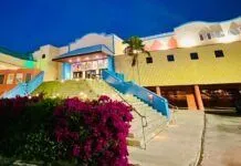 UPGRADES ELEVATE A NIGHT OUT AT THE THEATER IN TAVERNIER a building that has a bunch of flowers in front of it