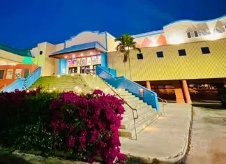 UPGRADES ELEVATE A NIGHT OUT AT THE THEATER IN TAVERNIER a building that has a bunch of flowers in front of it