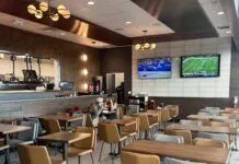 NEW CONCH FLYER RESTAURANT OPENS AT KEY WEST AIRPORT a restaurant filled with lots of tables and chairs