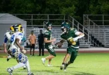 ATHLETE OF THE WEEK: JOHN OUGHTON a group of people playing a game of football