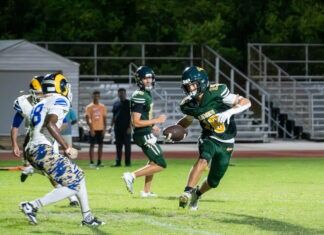 ATHLETE OF THE WEEK: JOHN OUGHTON a group of people playing a game of football