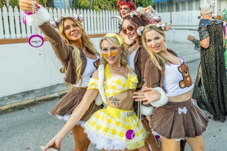 a group of women in costumes posing for a picture