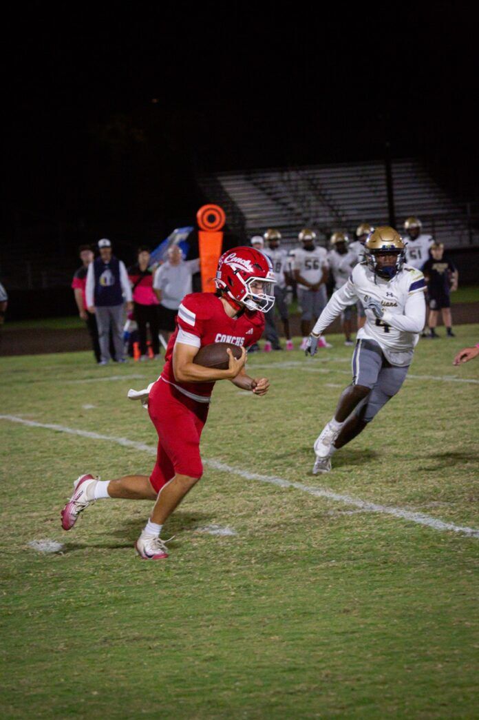 a football player running with the ball during a game