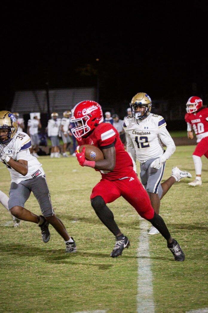 a football player running with the ball during a game