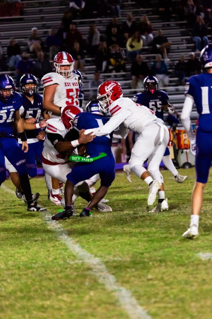 a football game in progress with the ball in the air