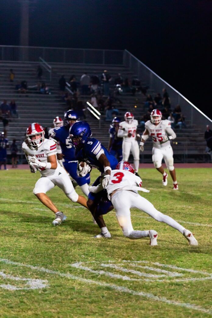 a football player running with the ball during a game