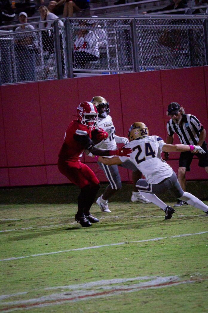 a football player running with the ball during a game