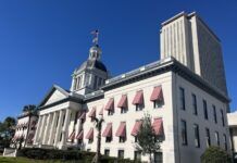 STATE LAWMAKERS BAN SUPPORT FOR ‘DIVERSITY’ EVENTS a large building with a flag on top of it