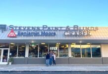 two people standing outside of a building