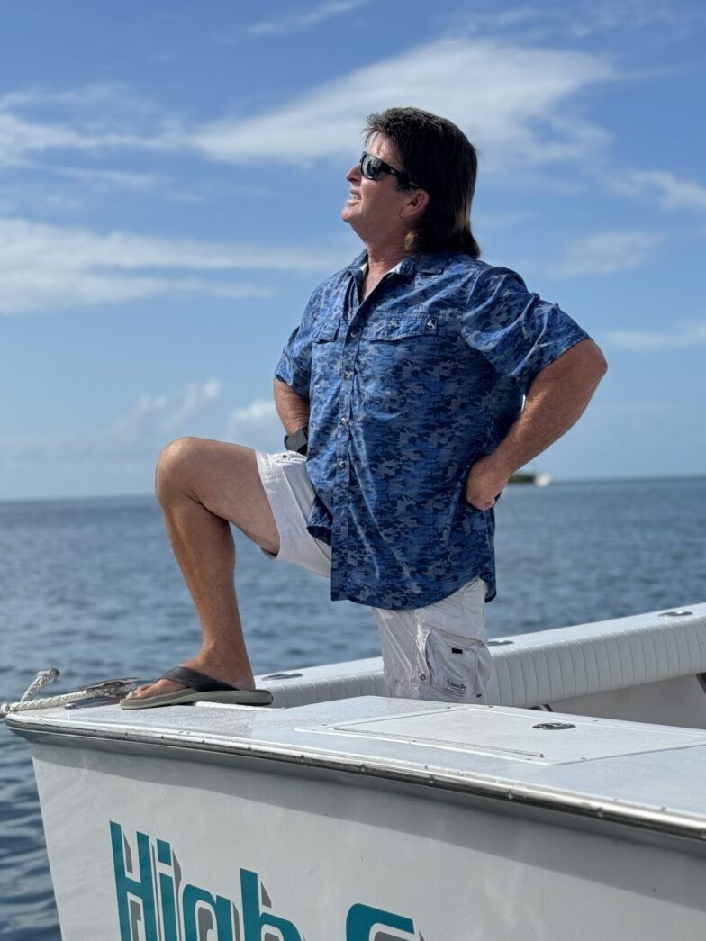 a man is sitting on the edge of a boat