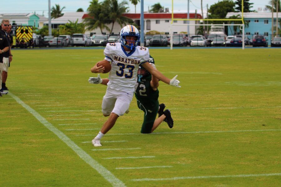 a football player running with the ball on a field