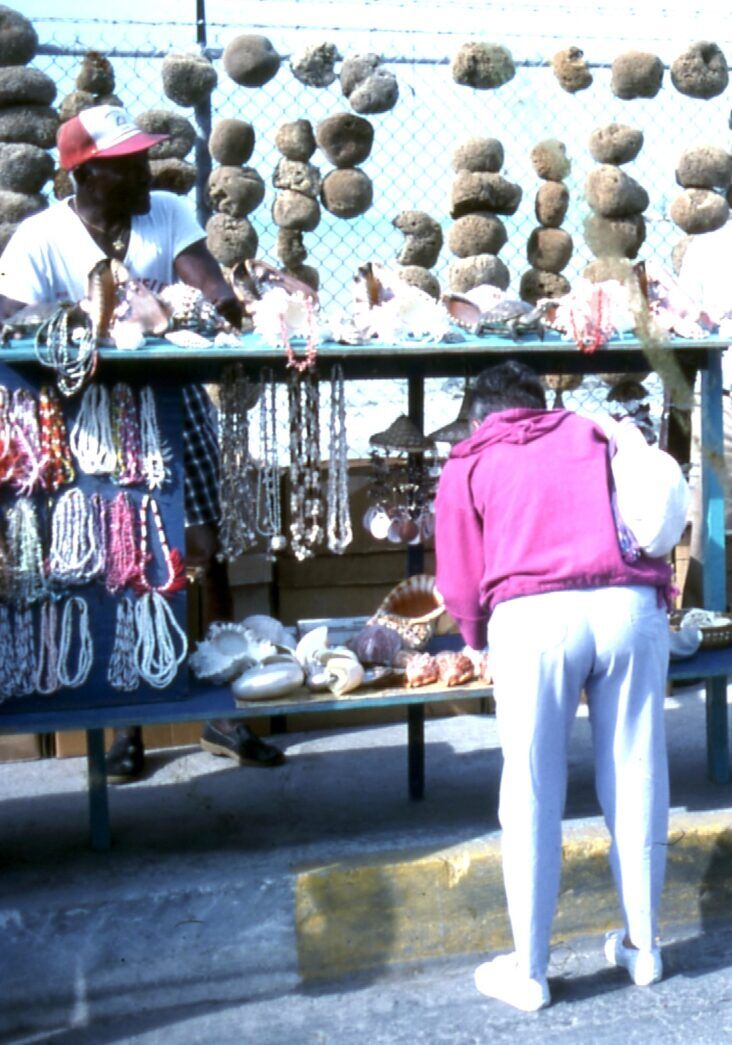 a woman standing in front of a display of jewelry