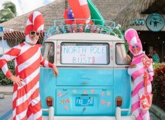 IN PICTURES: 7 MILE SANTACON BRINGS THE NORTH POLE TO THE TROPICS two people in costumes standing in front of a van