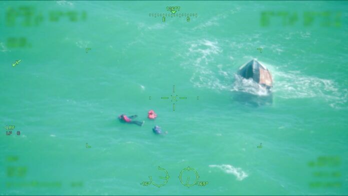 a couple of people in the water with a boat