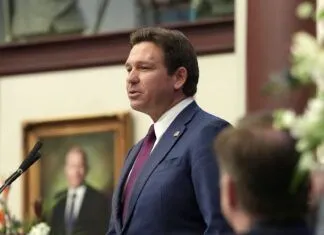 a man standing at a podium in front of a microphone