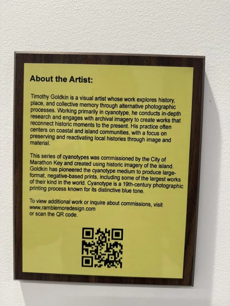 a sign on a wall that says about the artist