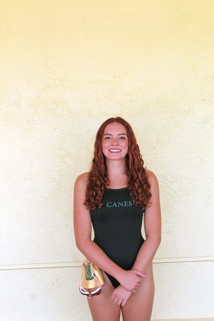 a woman in a black bathing suit posing for a picture
