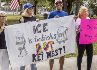 IN PICTURES: KEY WEST’S ‘ICE OUT FOR GOOD’ EVENT DRAWS HUNDREDS a group of people holding a protest sign