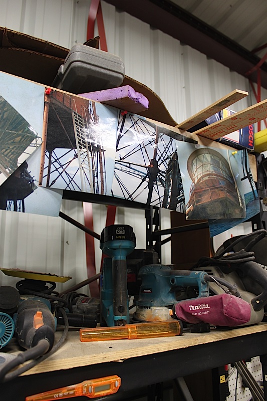 Photos of Sombrero Lighthouse are tacked up on the tool shelf in Larry Herlth’s workshop in Islamorada. He said he references these photos to make sure all the details are correct. 