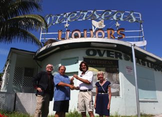 Robert M. Parker, Jr. et al. posing in front of a building - Overseas Pub and Grill